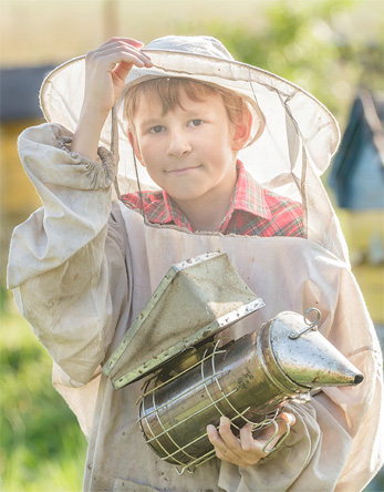 Young Beekeeper with Smoker