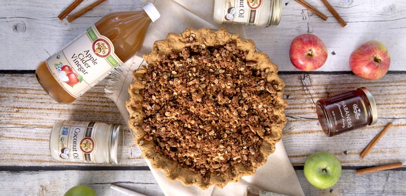 Apple Pie sitting on table to various ingredients