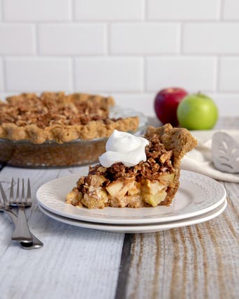 Slice of apple pie on wood table